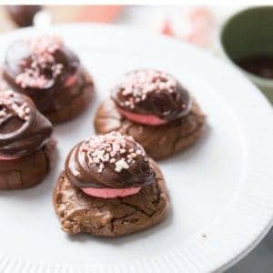 Four delicious chocolate peppermint cookies on a large white serving plate.