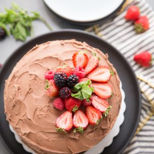 Whole chocolate cake with fruit on top