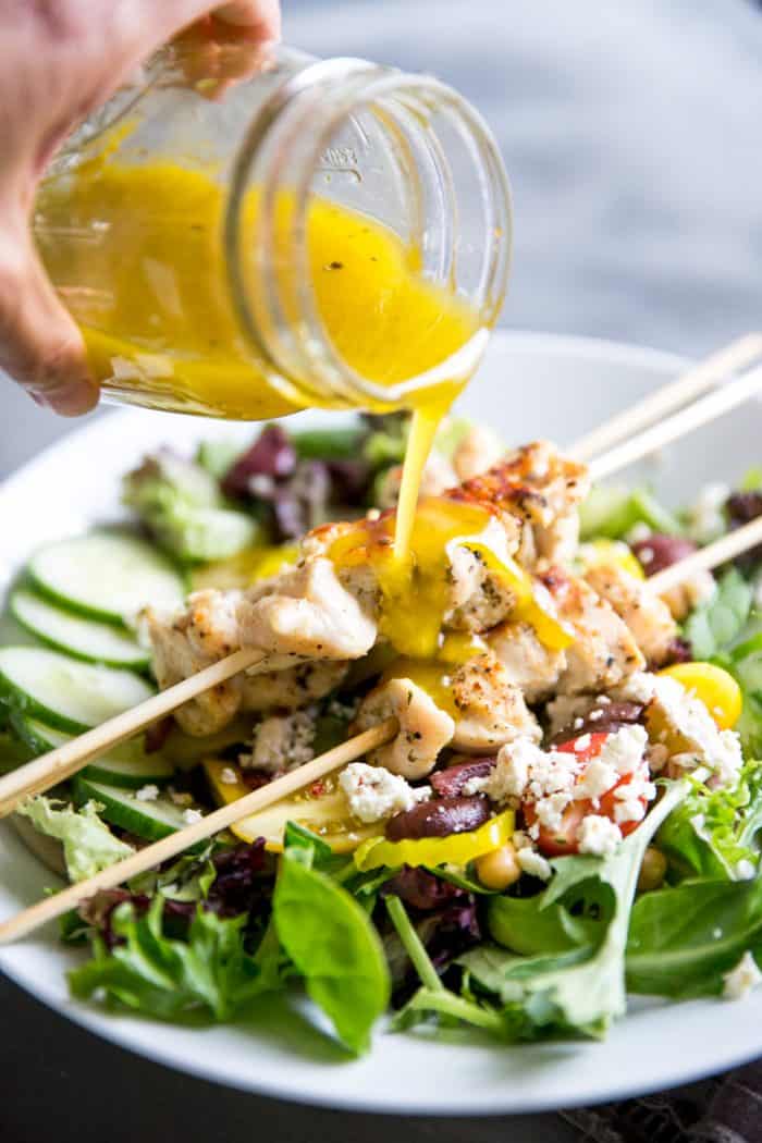I love serving my family simple chicken recipes. This Greek chicken souvlaki recipe is exactly that! It's light and healthy but so flavorful, especially atop this Mediterranean salad! chicken souvlaki salad with dressing