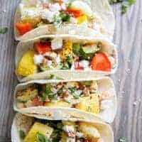 Roasted veggie tacos on a board